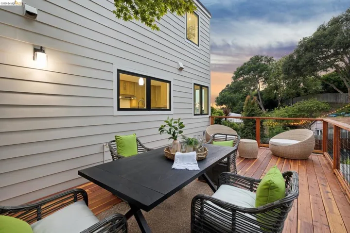 Spacious exterior deck featuring natural wood flooring and a perimeter railing system