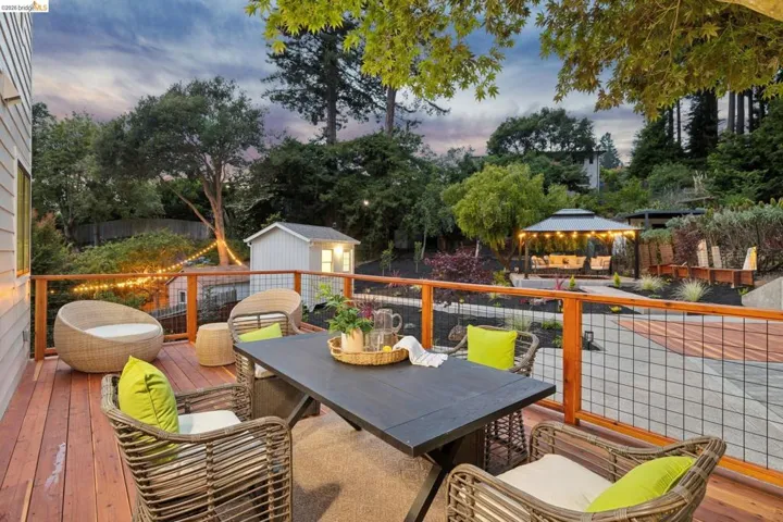 Expansive outdoor deck featuring wood-finish flooring and a metal grid railing system