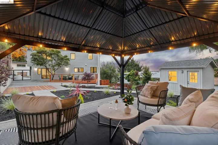 Outdoor gazebo with integrated lighting and a patterned rug