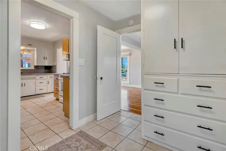 Hallway looking towards living room & kitchen, w/built in storage