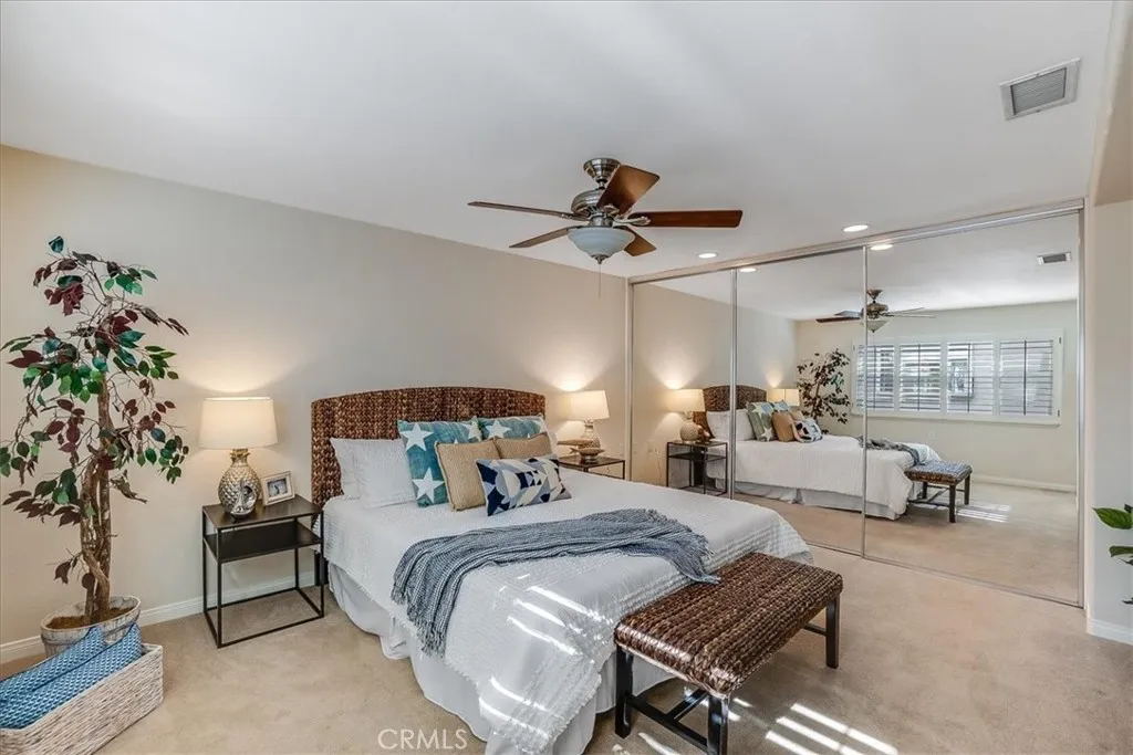 Ceiling fans and closet that spans the entire wall.