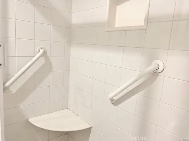 Shower interior with seat and rails.