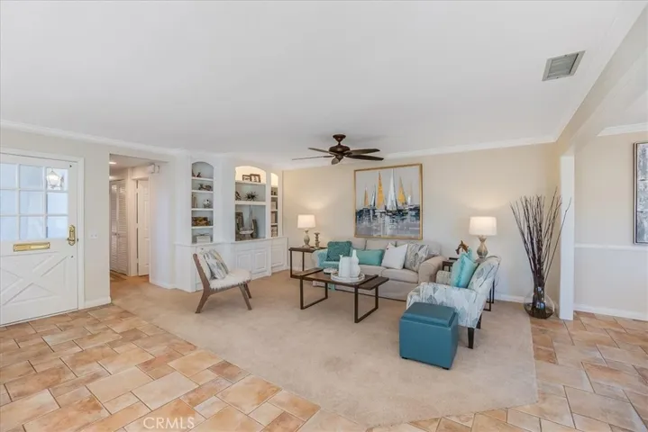 Living room has custom built in with lighting