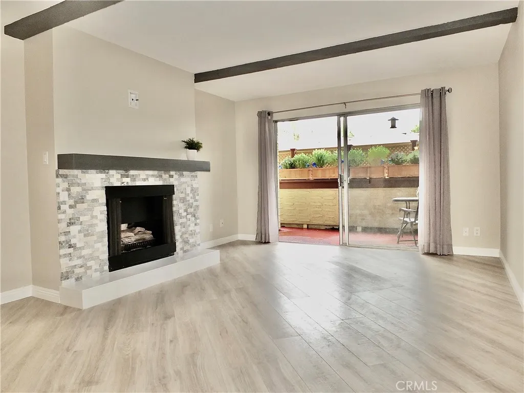 Living room with fireplace and balcony