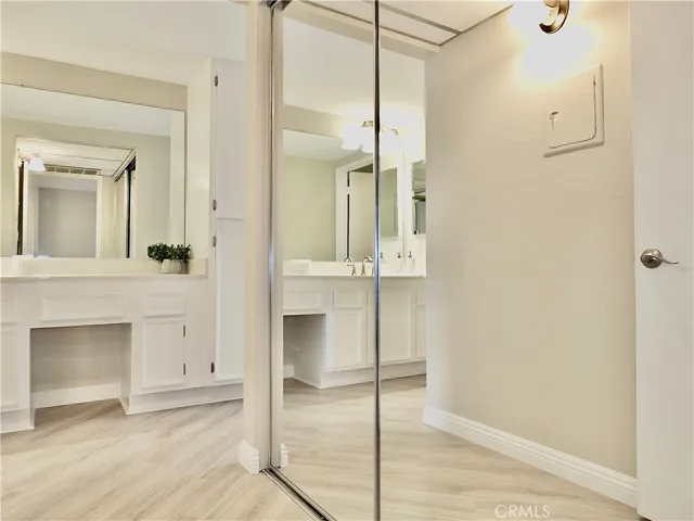 Hallway to bathroom and bedroom with storage