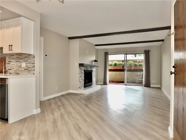 Bright living room with gas fireplace and Pergo flooring
