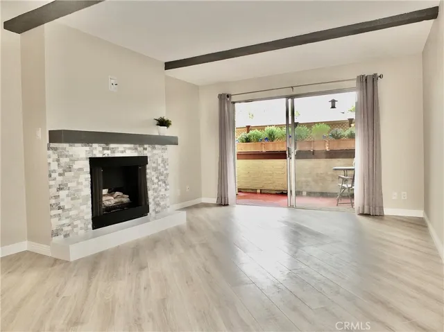 Living room with fireplace and balcony