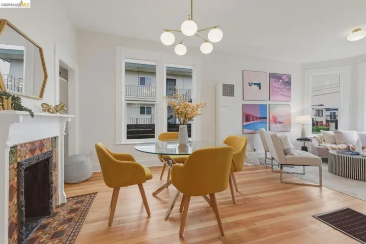 Bright living space featuring hardwood flooring and a decorative fireplace with intricate tilework