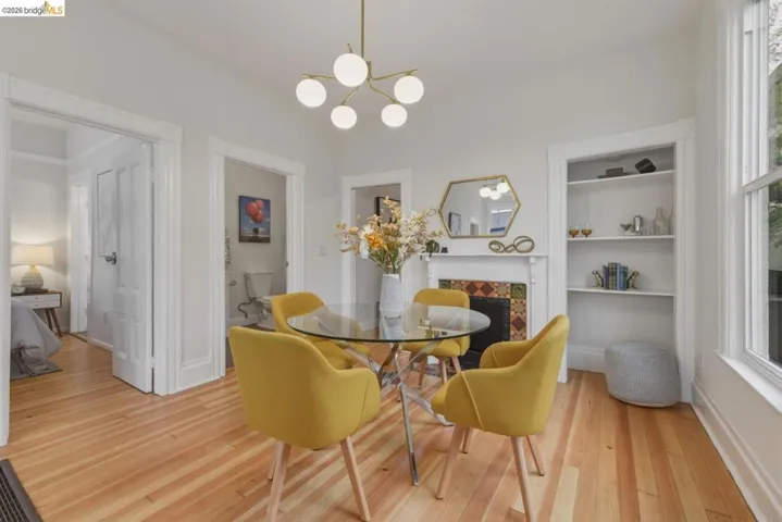 Hardwood flooring throughout the room with a built-in fireplace featuring decorative tile work