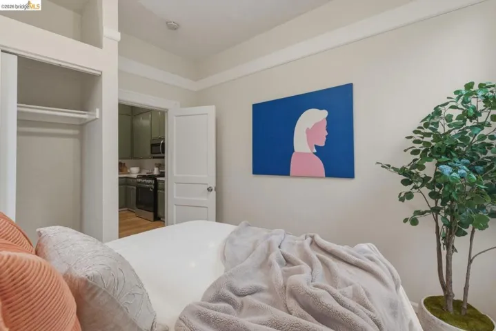 Bedroom space featuring a built-in closet with shelving and hanging rod