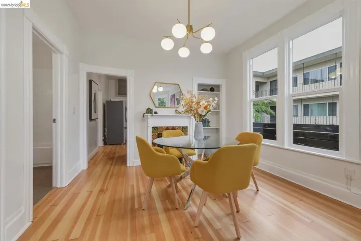 Dining area featuring light wood-finish flooring and a contemporary chandelier