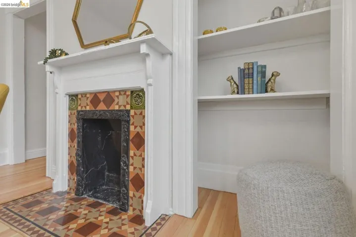 Decorative fireplace with an ornate white mantel and a dark marble surround