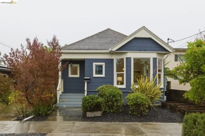 Charming residence featuring a classic gabled roofline and an inviting bay window