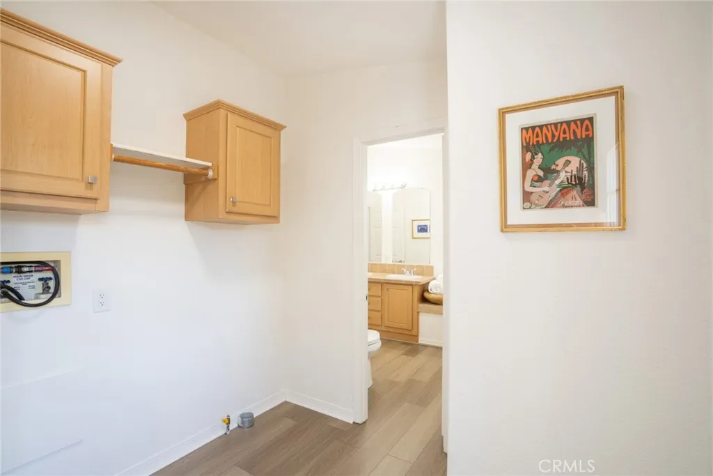 Laundry room with door to backyard + rear porch
