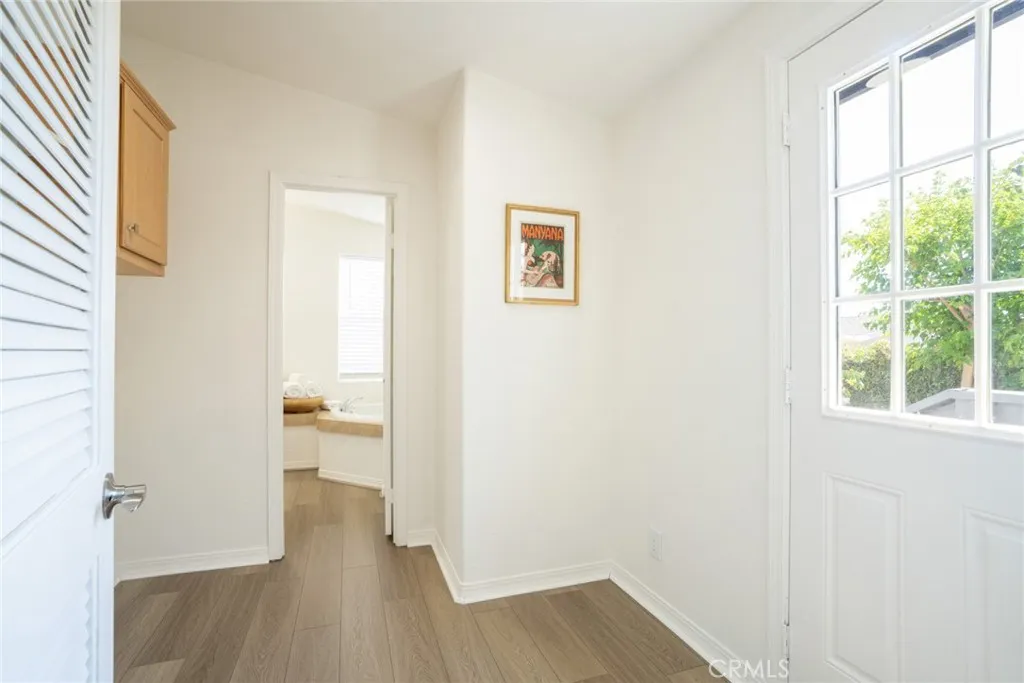 Laundry room with door to backyard + rear porch