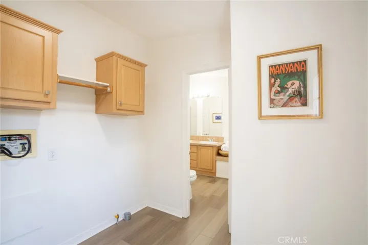 Laundry room with door to backyard + rear porch