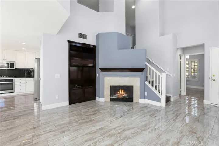 Living Room, Part of Kitchen and The door to the Main Level Bedroom. Fireplace has been digitally altered.