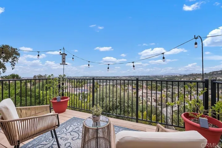 Balcony off main living space with panoramic views
