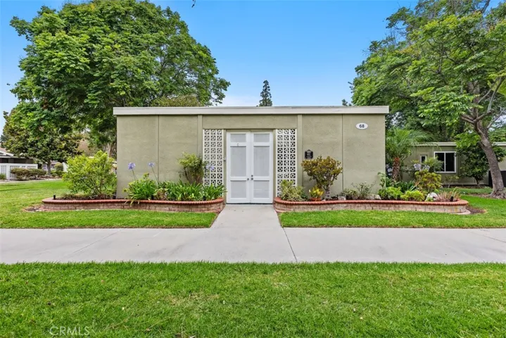 The home's charming front exterior is complemented by expansive greenbelts and manicured lawns, offering a rare sense of openness and privacy.