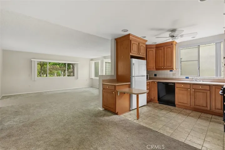 Large windows fill the kitchen and dining area with natural light, creating a welcoming space for everyday meals and gatherings.