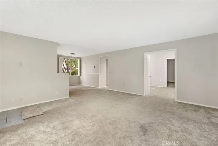 The expansive living area offers exceptional flexibility for multiple seating arrangements while maintaining an open, airy feel.