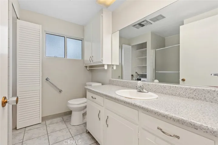The primary bathroom offers a large vanity, generous counter space, and a clean, functional design for everyday convenience.