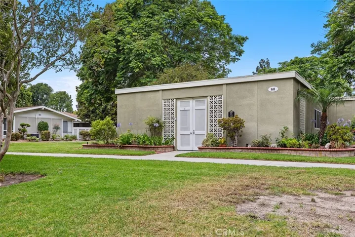 The attractive exterior is enhanced by lush landscaping and wide open lawns, offering a welcoming setting with exceptional curb appeal.