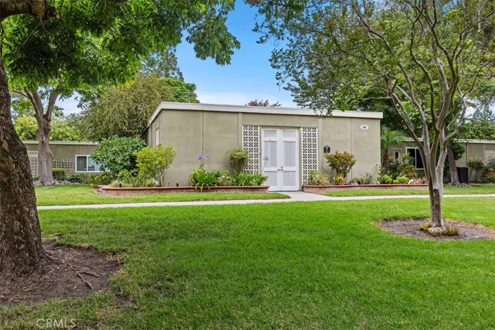 The home's desirable end-unit position enjoys abundant natural light, mature landscaping, and picturesque greenbelt views.
