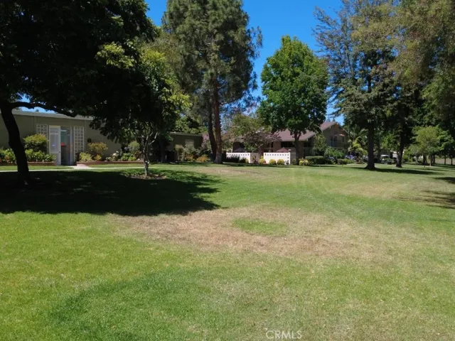 Generous open green space surrounding the home provides a peaceful backdrop and enhances the feeling of privacy