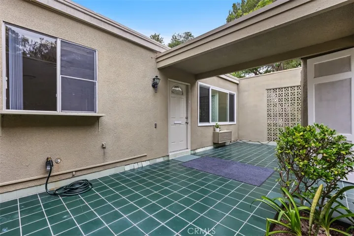 The spacious gated front courtyard offers a private outdoor retreat, perfect for morning coffee, relaxing with a book, or entertaining guests. Note: Kitchen window offers a pass-through option for easy entertaining from kitchen to patio.
