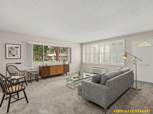 The spacious living room flows seamlessly into the dining area, creating an inviting setting for both everyday comfort and entertaining family and friends. Virtually staged picture.