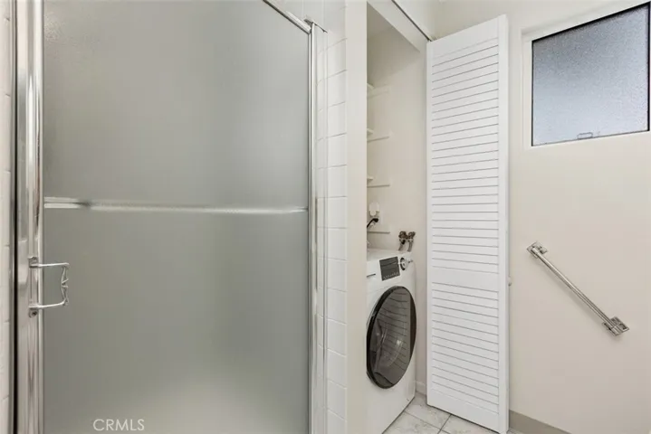 The interior laundry area provides added convenience with dedicated washer and dryer space conveniently located within the home.