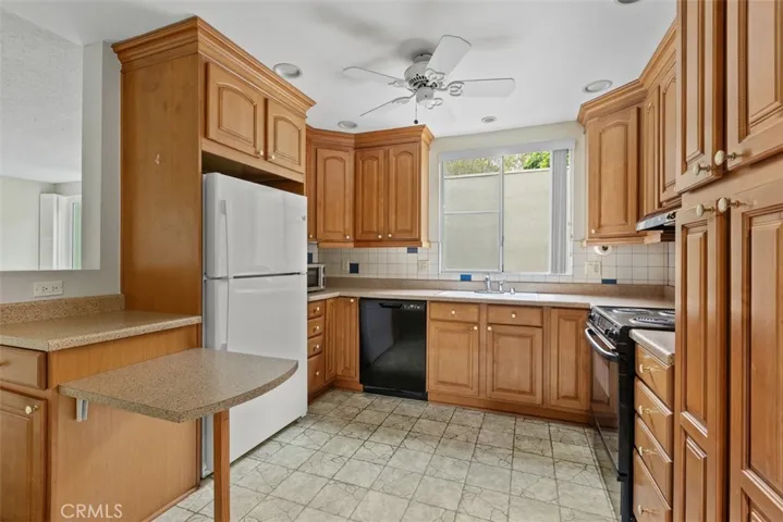 The thoughtfully updated kitchen offers ample storage, extensive workspace, and an efficient layout designed for both convenience and functionality.