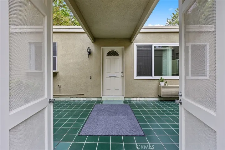The covered entry walkway welcomes you home while offering a sheltered transition from the private courtyard into the residence. Some neighbors have also covered one section of the patio for added sun coverage.