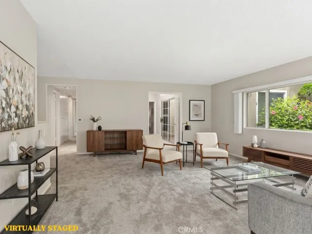 An open-concept living and dining area creates a comfortable gathering space with large windows that bring the beautiful outdoor surroundings inside. Virtually Staged picture.