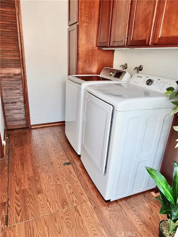 Laundry room with trap door to large basement