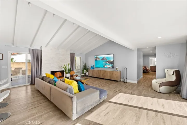 Family Room with Vaulted, Open Beam Ceilings and Fireplace