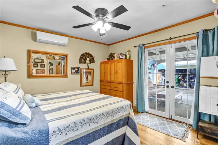Master with doors to the patio with ceiling fan
