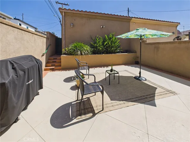 Sunny back patio with room to entertain leads out to the two car garage