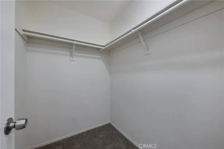Walk in closet in primary bedroom