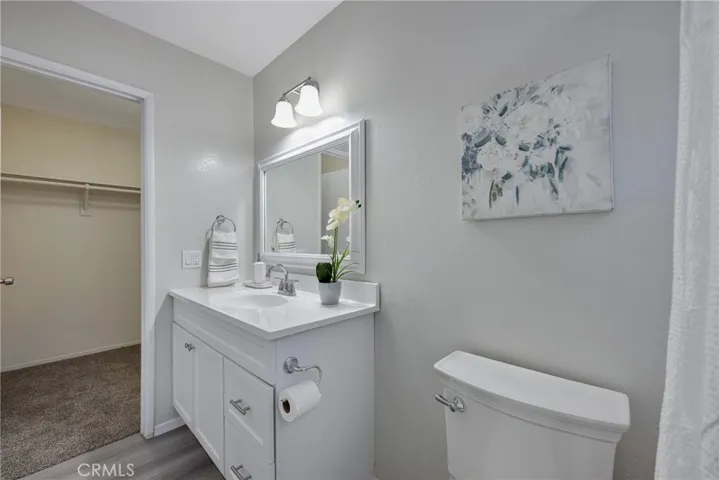 Walk in closet adjacent to primary bathroom