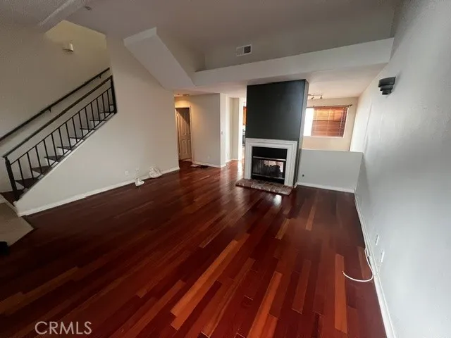 Livingroom with Cherry flooring and fireplace