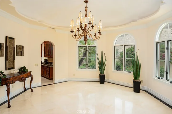 Spacious dining room with high ceiling.