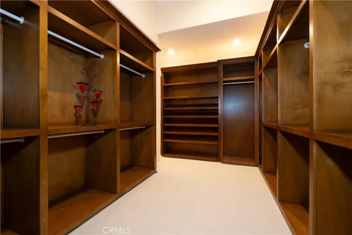 Walk in closet in primary bedroom.