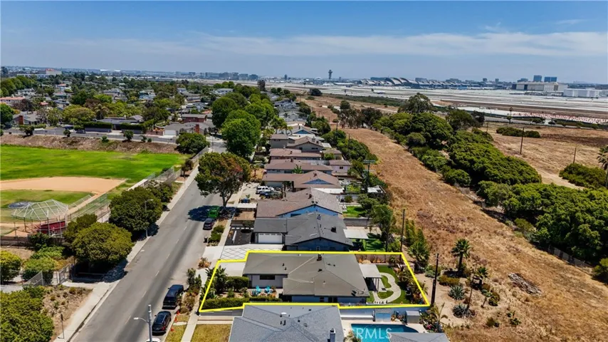 Location Shot of House as it sits on block and is backed by protected space.  LAX is in the background