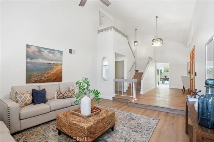 Dramatic view of the living room towards dining room and stairs.
