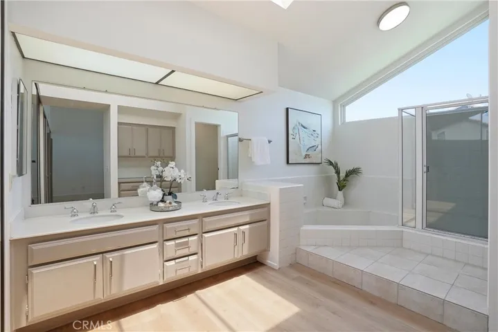 The primary bathroom features a large soaking tub, separate walk-in shower and loads of storage and counter space.