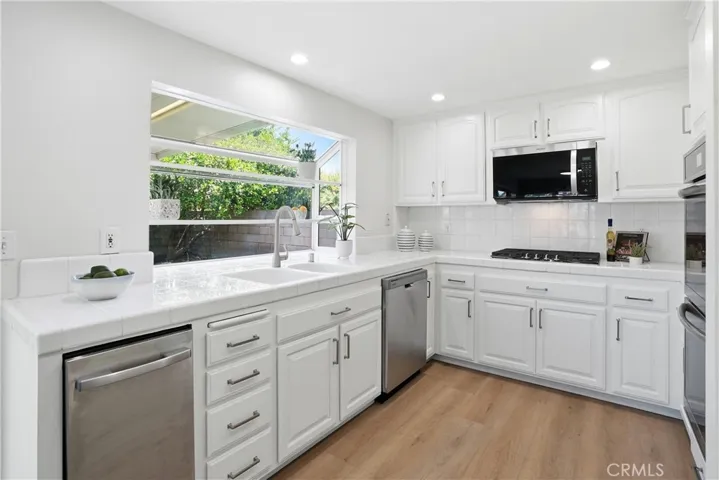 Fully loaded kitchen with dramatic backyard views.
