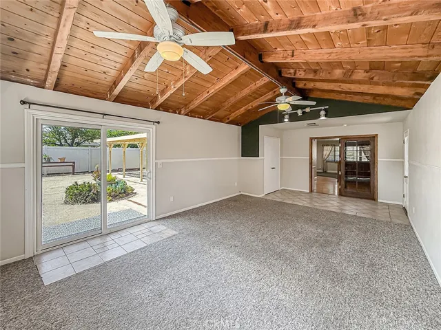 family room with sliding door to back yard and glass doors to dining room