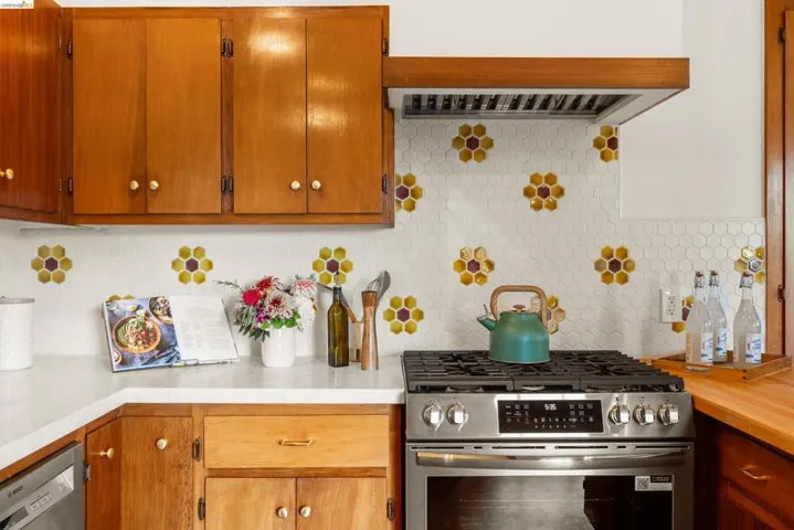 Kitchen featuring a stainless steel range, a coordinating range hood, and wood cabinetry